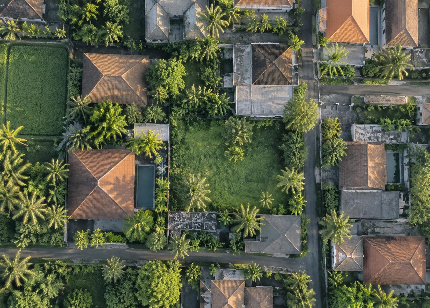 Aerial view of a residential neighbourhood with land plots and rooftops
